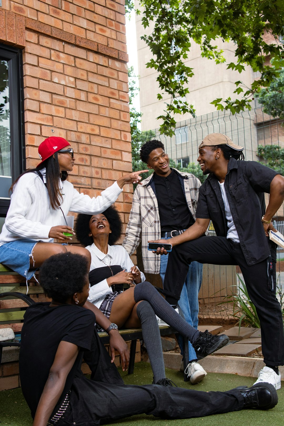 Group of people having a lively discussion around a laptop