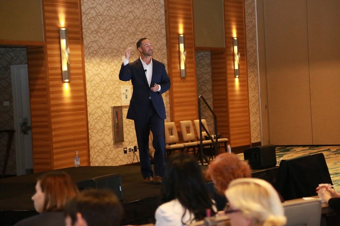 Presenter teaching a workshop to an audience